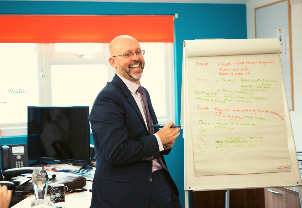 Paul Field, director of WFP smiling holding a pen