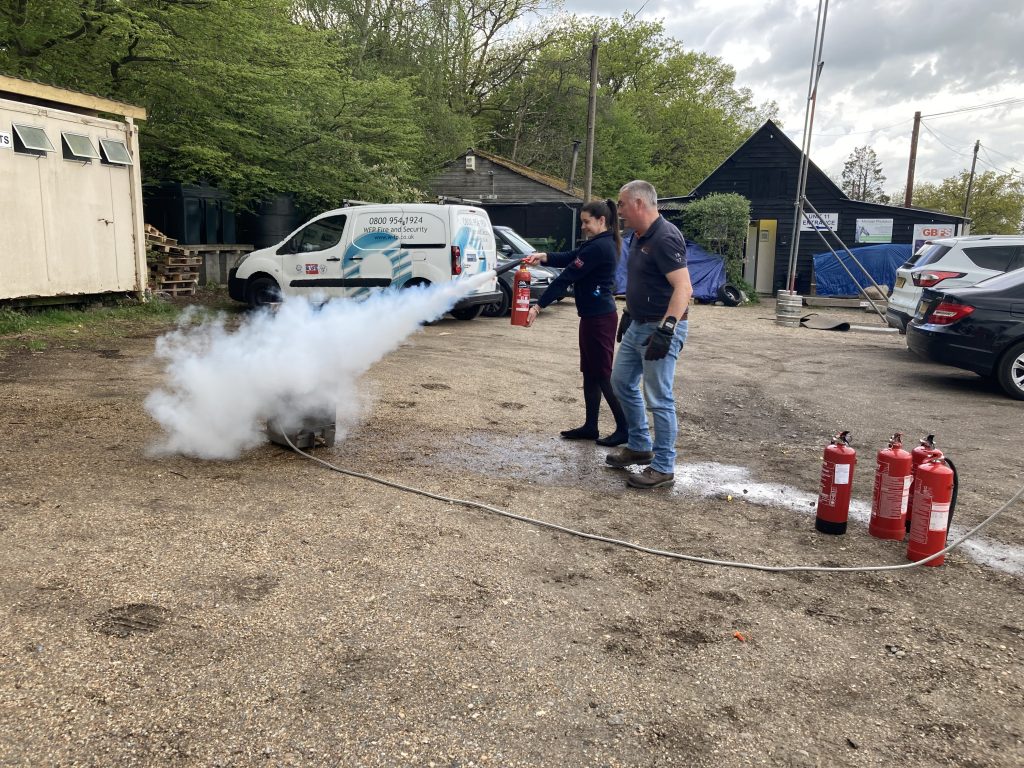 WFP employee holding a fire extinguisher carrying out fire safety training
